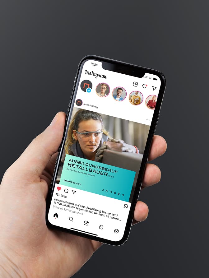 Hand holding a smartphone displaying an Instagram post about a metalworker apprenticeship, featuring a person in safety goggles.